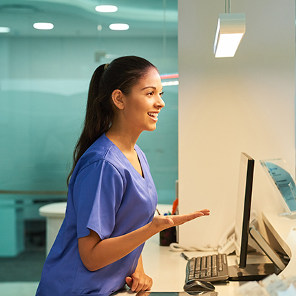 Medical receptionist speaks to a patient