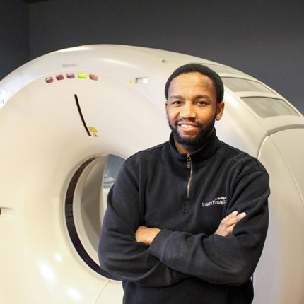 Radiology student in front of machine.