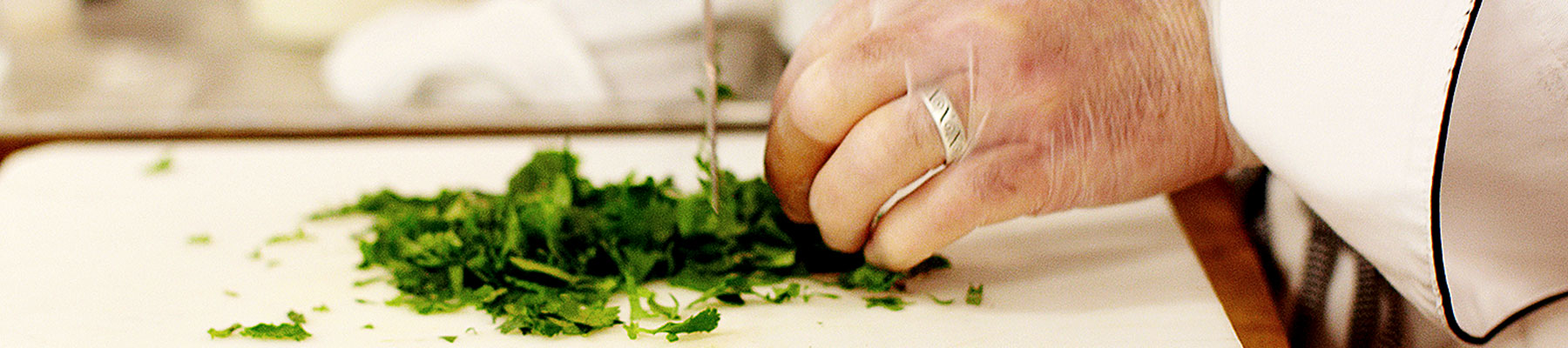 close up of hands chopping herbs