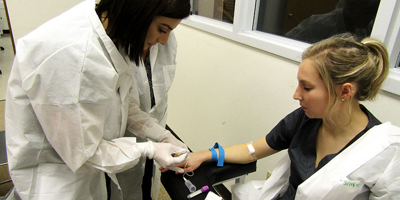 SCC phlebotomy student preparing needle