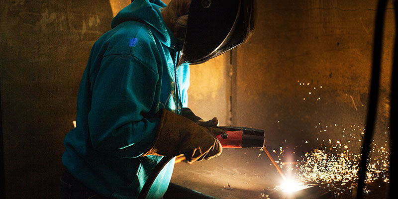 Woman welding at SCC.