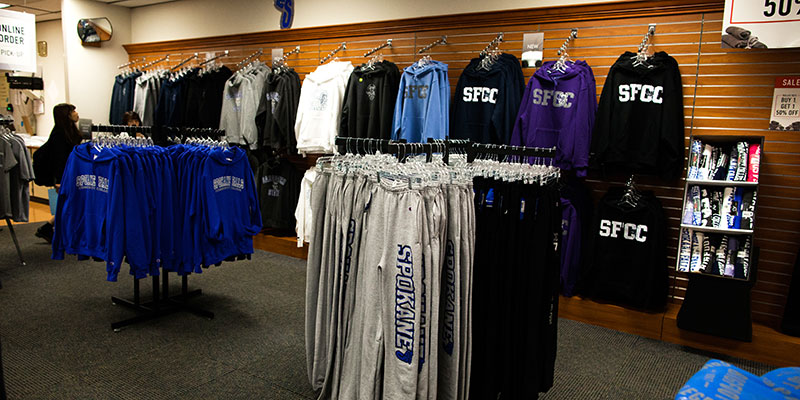 Racks of clothing in the campus bookstore
