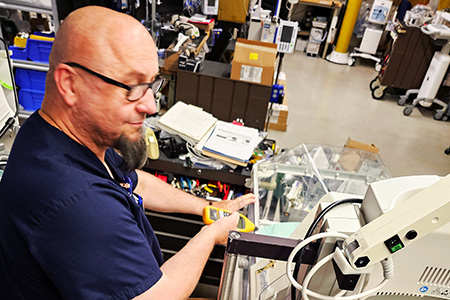 Matt McGill, SCC Alum, testing biomedical equipment
