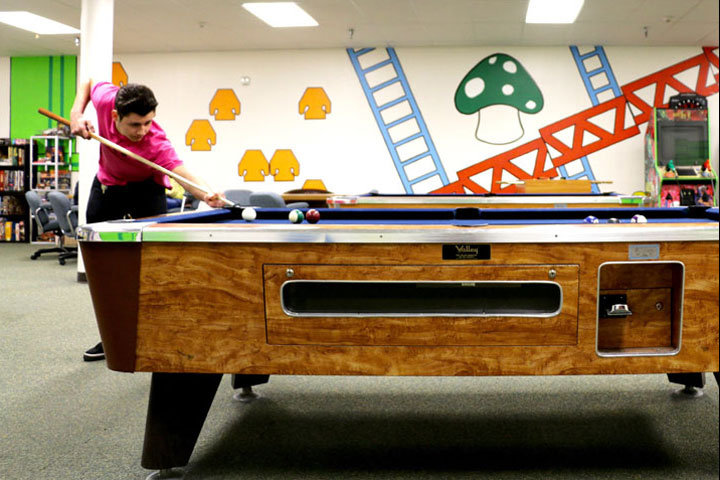 Student shooting pool in Game Room