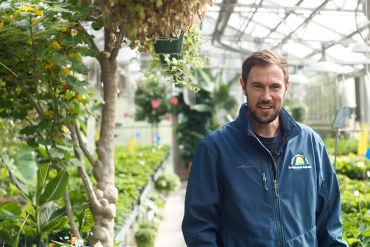 SCC Greenhouse manager, smiling