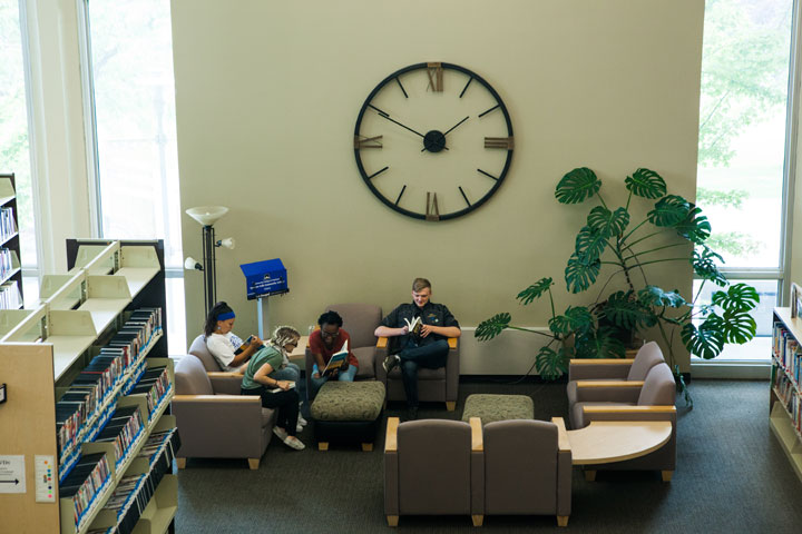 Students sitting in a reading area in the Library