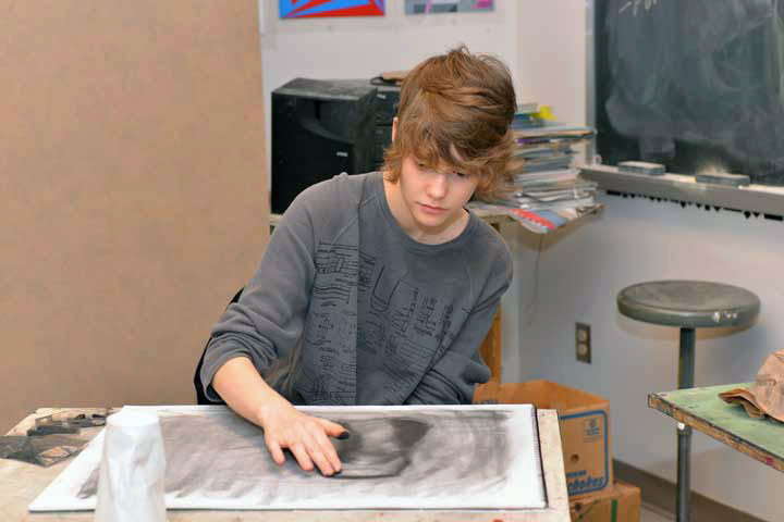 Fine Arts student making charcoal drawing