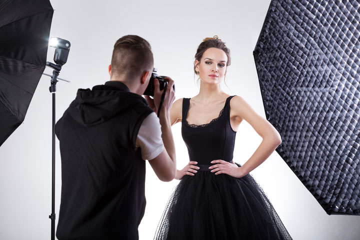 Student taking picture of fashion model in studio