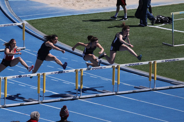 Women jumping hurdles at Track and Field event