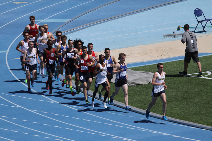 Group of athletes running on track
