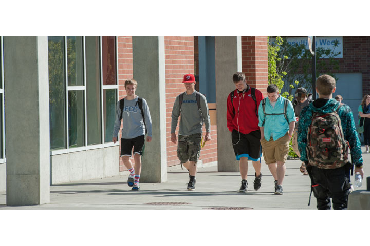 Five students walking outside of Music Building