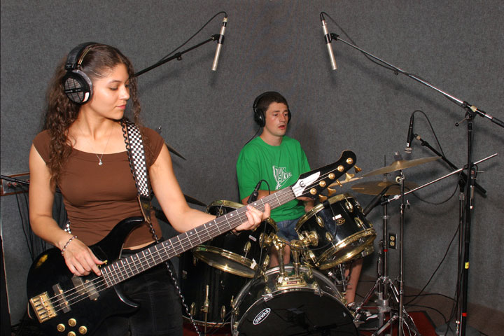 Student musicians practicing on bass and drums