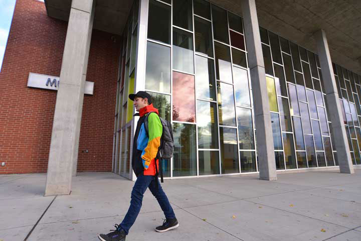 Student walking outside the Music Building