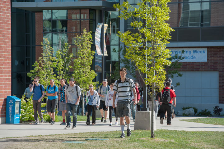 Students walking outside of the west entrance of Building 24