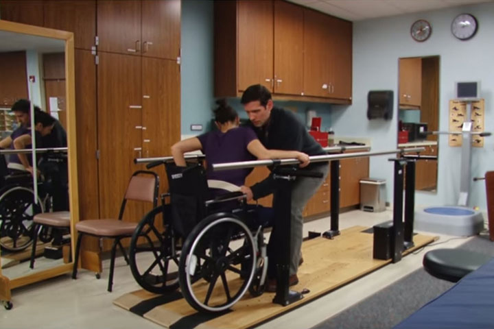 Moving patient in wheelchair along bars