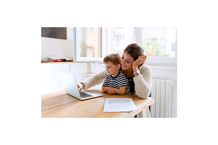 Parent with young son and laptop