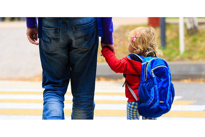 Parent walking with child on campus